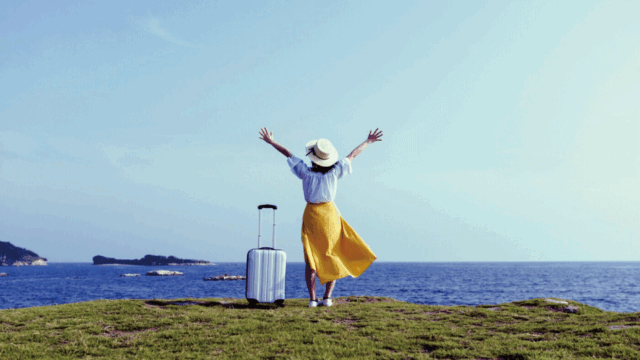 A solo female traveler walking safely in a clean Japanese street near a train station

