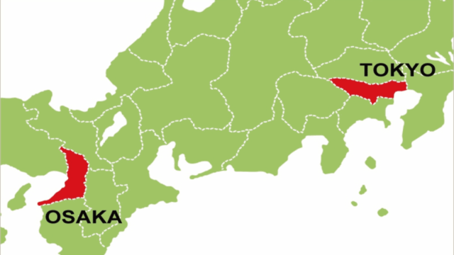 A young woman dressed in warm winter clothing—a puffer jacket, beanie, and jeans—sits atop a moss-covered rock formation overlooking a vast, calm sea under an overcast sky. The cool tones and barren landscape suggest a winter scene in a coastal region of Japan, possibly reflecting the off-peak season for places like Okinawa or a less crowded time in Hokkaido.