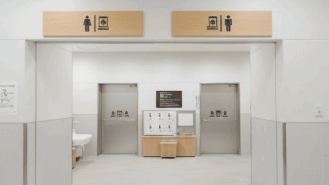 A Japanese onsen changing area entrance, clean and modern, no people, clear signage, realistic photography, bright and reassuring mood, travel blog style